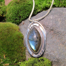Load image into Gallery viewer, Our Daphne necklaces all feature a stunning deep blue marquise cut Labradorites. This royal hue is one of the most desired shades of the stone and looks stunning set in silver. This Daphne is set in a sleek shadowbox with hand-carved notches that reference an Art-Deco aesthetic. A simple arched bail provides a sleek connection to a smooth, round, foxtail chain.