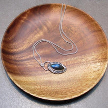 Load image into Gallery viewer, Our Daphne necklaces all feature a stunning deep blue marquise cut Labradorites. This royal hue is one of the most desired shades of the stone and looks stunning set in silver.  This Daphne is wrapped by a silver twist and crowned with a large circular bail through which a shimmery silver chain is looped