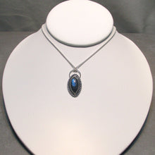 Load image into Gallery viewer, Our Daphne necklaces all feature a stunning deep blue marquise cut Labradorites. This royal hue is one of the most desired shades of the stone and looks stunning set in silver.  This Daphne is wrapped by a silver twist and crowned with a large circular bail through which a shimmery silver chain is looped