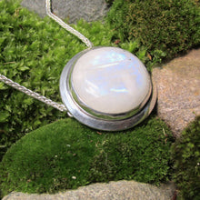 Load image into Gallery viewer, A fitting homage to the elegant and mysterious moon goddess Diana, this medallion style necklace features a weighty and luminous Moonstone cabochon bezel set and ringed with a wide band of solid silver. A sleek chain mounted directly to the edges of the pendant gives a clean finish and keeps the pendant centered.  A 16” chain ensures the pendant will lay comfortably just below your collarbones.