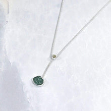 Load image into Gallery viewer, A rich green raw emerald dangles from a tiny glowing labradorite. This y-shaped necklace is perfect for deep necklines and adding the perfect amount of color without overwhelming your look!