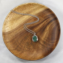 Load image into Gallery viewer, A beautiful hand-cut emerald is showcased in a simple banded bezel - geometric but still natural. A thicker rolo chain balances out the small but solid pendant and a two-inch extender gives you flexibility with different necklines.