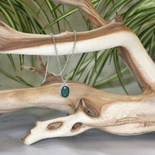 Load image into Gallery viewer, A beautiful hand-cut emerald is showcased in a simple banded bezel - geometric but still natural. A thicker rolo chain balances out the small but solid pendant and a two-inch extender gives you flexibility with different necklines.