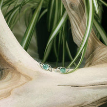 Load image into Gallery viewer, These small but striking stud earrings are sure to get lots of attention! Unusually light minty-green, the rose-cut Russian Emeralds have a delightful gemmy sparkle that is framed by lightly hammered silver wings