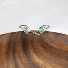 Load image into Gallery viewer, These small but striking stud earrings are sure to get lots of attention! Unusually light minty-green, the rose-cut Russian Emeralds have a delightful gemmy sparkle that is framed by lightly hammered silver wings
