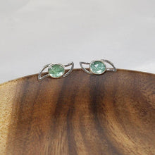 Load image into Gallery viewer, These small but striking stud earrings are sure to get lots of attention! Unusually light minty-green, the rose-cut Russian Emeralds have a delightful gemmy sparkle that is framed by lightly hammered silver wings