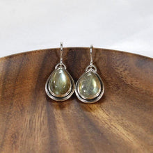 Load image into Gallery viewer, A perfect match for the Stella Classic necklace, these dangly drop earrings of mossy green labradorite are wrapped snugly with a banded bezel and swing freely to catch the light.