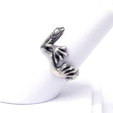 Load image into Gallery viewer, This adorable little tree frog clings to your finger with oversized toes, happy to bring a shine to your hand and a smile to your face! Looking like it just hopped out of a silver rainforest, your new Morelets Tree Frog ring will add a bit of bounce to your look!  We donate a portion of all WildWhere sales to support continuing wildlife conservation efforts!