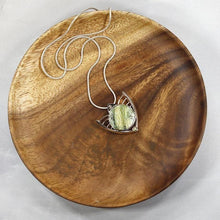 Load image into Gallery viewer, Faye features delicate handcrafted wings to frame this necklace’s substantial eye-catching Green Opal. A beautiful spring green, the stone is striped with shimmering bands and accented by a tiny drop of yellow-green labradorite.