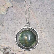 Load image into Gallery viewer, This Jaida necklace has an earthy, organic feel with its blue-green Labradorite centered in an antiqued shadowbox framed by a hand-textured halo. The sleek silver wheat chain lets the pendant steal the show while still providing elegance and strength.