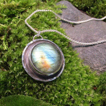 Load image into Gallery viewer, This Jaida necklace has an earthy, organic feel with its blue-green Labradorite centered in an antiqued shadowbox framed by a hand-textured halo. The sleek silver wheat chain lets the pendant steal the show while still providing elegance and strength.