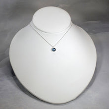 Load image into Gallery viewer, These sweet little pendant features an ethically sourced rosecut Teal Kyanite set in a simple recycled silver bezel. At 9mm wide, it is the perfect size for everyday wear while still adding a flash of sparkle to your look! This necklace pairs perfectly with the Luna Teal Kyanite Studs