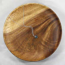 Load image into Gallery viewer, These sweet little pendant features an ethically sourced rosecut Teal Kyanite set in a simple recycled silver bezel. At 9mm wide, it is the perfect size for everyday wear while still adding a flash of sparkle to your look! This necklace pairs perfectly with the Luna Teal Kyanite Studs