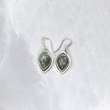 Load image into Gallery viewer, These lovely dangle earrings feature soft blue-grey labradorite teardrops nestled into Sterling Silver leaf hoops. A double loop connection gives these gems lots of movement to catch the light.