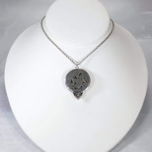 Load image into Gallery viewer, This gorgeous Valarie necklace will be the center of your outfit. A large deep green labradorite with flashy golden stripes is surrounded by a peaked ring of silver and accented by a tiny labradorite set on a hand-textured backer. Delicately hand-cut vine patterns on the back give this piece an extra custom feel.