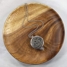 Load image into Gallery viewer, This gorgeous Valarie necklace will be the center of your outfit. A large deep green labradorite with flashy golden stripes is surrounded by a peaked ring of silver and accented by a tiny labradorite set on a hand-textured backer. Delicately hand-cut vine patterns on the back give this piece an extra custom feel.