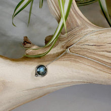 Load image into Gallery viewer, With its exceptional deep blue Labradorite, Taylor carries a mystical hint of midnight. Dangling from a wheat chain and accented by a thin silver band and tiny silver pebble, this necklace is delicate but eye-catching.