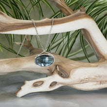 Load image into Gallery viewer, The Johnna necklace is minimal in form and maximal in impact. A delicate peaked silver band holds this large, flashy, aqua Labradorite in its rightful place, front and center. With plenty of color this piece will add glam to any look, while its soft turquoise and denim hues will be easy to style with your wardrobe staples.