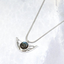Load image into Gallery viewer, the labradorite Faye necklace evokes the new moon and gliding wings. The deep blue labradorite cabochon has exceptional dimension and hints of aqua and gold. The detailing detailing on the back makes this piece a 360º treasure.