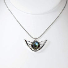 Load image into Gallery viewer, the labradorite Faye necklace evokes the new moon and gliding wings. The deep blue labradorite cabochon has exceptional dimension and hints of aqua and gold. The detailing detailing on the back makes this piece a 360º treasure.
