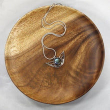 Load image into Gallery viewer, the labradorite Faye necklace evokes the new moon and gliding wings. The deep blue labradorite cabochon has exceptional dimension and hints of aqua and gold. The detailing detailing on the back makes this piece a 360º treasure.