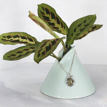 Load image into Gallery viewer, Tara evokes the new life of a seed just sprouted. A green-gold Labradorite is nestled in a tapered silver swirl and topped with a tiny dewdrop Labradorite.