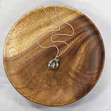 Load image into Gallery viewer, Tara evokes the new life of a seed just sprouted. A green-gold Labradorite is nestled in a tapered silver swirl and topped with a tiny dewdrop Labradorite.