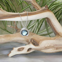 Load image into Gallery viewer, One part portal and one part shield talisman, this aqua blue Labradorite Deidra is all sleek elegance and high shine.     Details:  Solid sterling silver, partially recycled  Natural Labradorite cabochon  Pendant: 30 x 27mm  18” long Sterling Silver chain plus 2” Extender  Handmade s-hook clasp