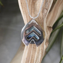 Load image into Gallery viewer, One part portal and one part shield talisman, this aqua blue Labradorite Deidra is all sleek elegance and high shine.     Details:  Solid sterling silver, partially recycled  Natural Labradorite cabochon  Pendant: 30 x 27mm  18” long Sterling Silver chain plus 2” Extender  Handmade s-hook clasp