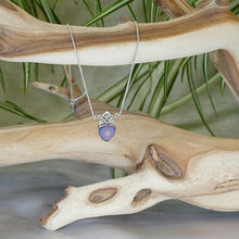 Load image into Gallery viewer, With its curling vines and hand textured petal, the Fleur necklace adds a touch of romance to your look. The checker cut Lilac Chalcedony has a soft purple glow and just the right amount of sparkle.