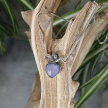 Load image into Gallery viewer, With its curling vines and hand textured petal, the Fleur necklace adds a touch of romance to your look. The checker cut Lilac Chalcedony has a soft purple glow and just the right amount of sparkle.