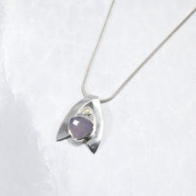 Load image into Gallery viewer, Sleek and polished, the Lilian features a dreamy checker cut Lilac Chalcedony crowned by a soft peachy drop of Labradorite. Smooth wings curve back to seamlessly form a bail that slides along a finely woven foxtail chain.