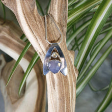 Load image into Gallery viewer, Sleek and polished, the Lilian features a dreamy checker cut Lilac Chalcedony crowned by a soft peachy drop of Labradorite. Smooth wings curve back to seamlessly form a bail that slides along a finely woven foxtail chain.