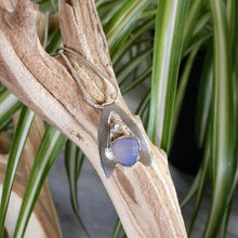 Load image into Gallery viewer, Sleek and polished, the Lilian features a dreamy checker cut Lilac Chalcedony crowned by a soft peachy drop of Labradorite. Smooth wings curve back to seamlessly form a bail that slides along a finely woven foxtail chain.
