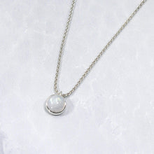 Load image into Gallery viewer, This Rainbow Moonstone choker is for someone who wants an especially close-fitting necklace. At just 15” long, the sterling silver wheat chain allows the pale green and aqua moonstone to rest right at the base of the throat.