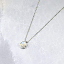 Load image into Gallery viewer, This 11mm Luna necklace features a beautiful round Rainbow Moonstone simply set in a smooth silver bezel. A silver wheat chain completes the clean, classic look you will find yourself wearing over and over.