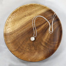 Load image into Gallery viewer, This 11mm Luna necklace features a beautiful round Rainbow Moonstone simply set in a smooth silver bezel. A silver wheat chain completes the clean, classic look you will find yourself wearing over and over.