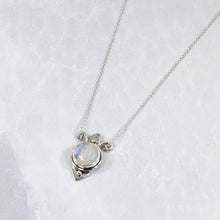 Load image into Gallery viewer, Hand-shaped silver tendrils allow this Fleur pendant to glide along its dainty oval chain. A narrow round bezel band and silver pebbles accent the violet-blue flash of the Moonstone.