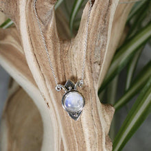 Load image into Gallery viewer, Hand-shaped silver tendrils allow this Fleur pendant to glide along its dainty oval chain. A narrow round bezel band and silver pebbles accent the violet-blue flash of the Moonstone.