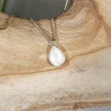 Load image into Gallery viewer, Simple and sweet, the Tess moonstone necklace is a jewel you will reach for over and over. A beautiful blue flash in the cloud-white stone set in a classic silver bezel adds the perfect touch of glam to this easy to wear necklace.