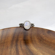 Load image into Gallery viewer, A truly one-of-a-kind piece, the Stevie features a wide textured band wrapped in a hand sculpted leafy vine crowned by a flashy crystalline Rainbow Moonstone. The black patina has been buffed back to highlight the details of this unique jewel.