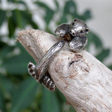 Load image into Gallery viewer, This snuggly silver Sea Otter curls his paws and tail around you finger in a tiny hug!   We donate a portion of all WildWhere sales to support continuing wildlife conservation efforts!