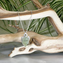 Load image into Gallery viewer, The Jeryn necklace is an absolute showstopper. Featuring a large translucent pear green Prehnite with black tourmaline inclusions, the spearhead shaped pendant is topped off with a luminous peachy green Labradorite set in a hand-texture bezel. A strong and elegant wheat chain balances the piece out and a 2” extension chain allows for neckline options.