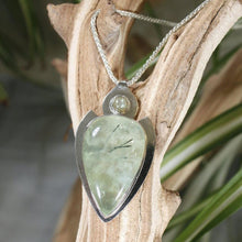 Load image into Gallery viewer, The Jeryn necklace is an absolute showstopper. Featuring a large translucent pear green Prehnite with black tourmaline inclusions, the spearhead shaped pendant is topped off with a luminous peachy green Labradorite set in a hand-texture bezel. A strong and elegant wheat chain balances the piece out and a 2” extension chain allows for neckline options.