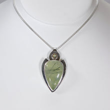 Load image into Gallery viewer, The Jeryn necklace is an absolute showstopper. Featuring a large translucent pear green Prehnite with black tourmaline inclusions, the spearhead shaped pendant is topped off with a luminous peachy green Labradorite set in a hand-texture bezel. A strong and elegant wheat chain balances the piece out and a 2” extension chain allows for neckline options.