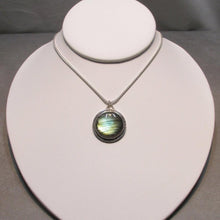 Load image into Gallery viewer, With a stunning streaked green and blue round Labradorite, the Rochelle necklace provides a lush focal point for your look. Ringed with a square-wire halo with delicate hand-carved notches and an unusual peaked bail, Rochelle is sure to be a well-loved addition to your collection.