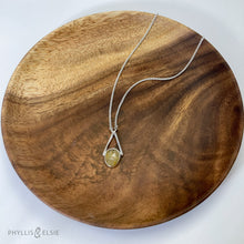 Load image into Gallery viewer, Rosecut Quartz with golden hued crystalline inclusions set in a silver bezel and suspended in an airy frame  Details:  Solid sterling silver, partially recycled  Rutilated Quartz  Pendant: 13mm x 26mm 16” long Sterling Silver chain plus 2” Extender  Lobster-claw clasp
