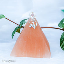 Load image into Gallery viewer, Dainty dangles with set with faceted Ethiopian opals suspended in a sterling frame. The faceted teardrop opals have stunning flashes of orange, yellow, and green depending on the light. Elegant lever-back ear hooks keep your new earrings secure with extra style.  Solid Sterling Silver, partially recycled  Natural Ethiopian Opals  Earring face - 12mm x 18mm  Sterling Lever-back ear hooks