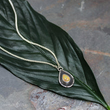 Load image into Gallery viewer, A brilliant orange and green teardrop opal is accented by a wide shadowbox and a delicately detailed border.  Solid sterling silver, some recycled content  Ethiopian Opal cabochon  Pendant 13mm x 21mm  17” long Sterling Silver chain with 2" extender