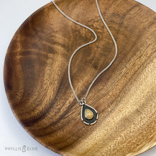 Load image into Gallery viewer, A brilliant orange and green teardrop opal is accented by a wide shadowbox and a delicately detailed border.  Solid sterling silver, some recycled content  Ethiopian Opal cabochon  Pendant 13mm x 21mm  17” long Sterling Silver chain with 2" extender